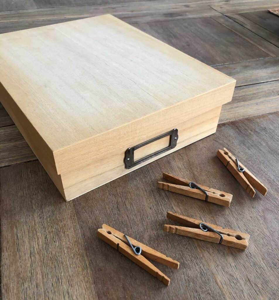 Plain wooden box for cord holder plus clothespins.