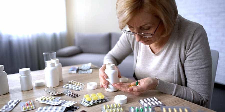 Elderly Woman Taking Pills
