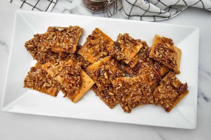 This easy Pecan Pie Bark recipe is the lazy woman’s way to enjoy all the buttery, caramelized goodness of classic pecan pie - without the fuss! Made with graham crackers, brown sugar, pecans, and vanilla, it’s a quick holiday dessert perfect for gifting, cookie trays, or snacking straight from the pan. A must-make sweet treat for Thanksgiving or Christmas!