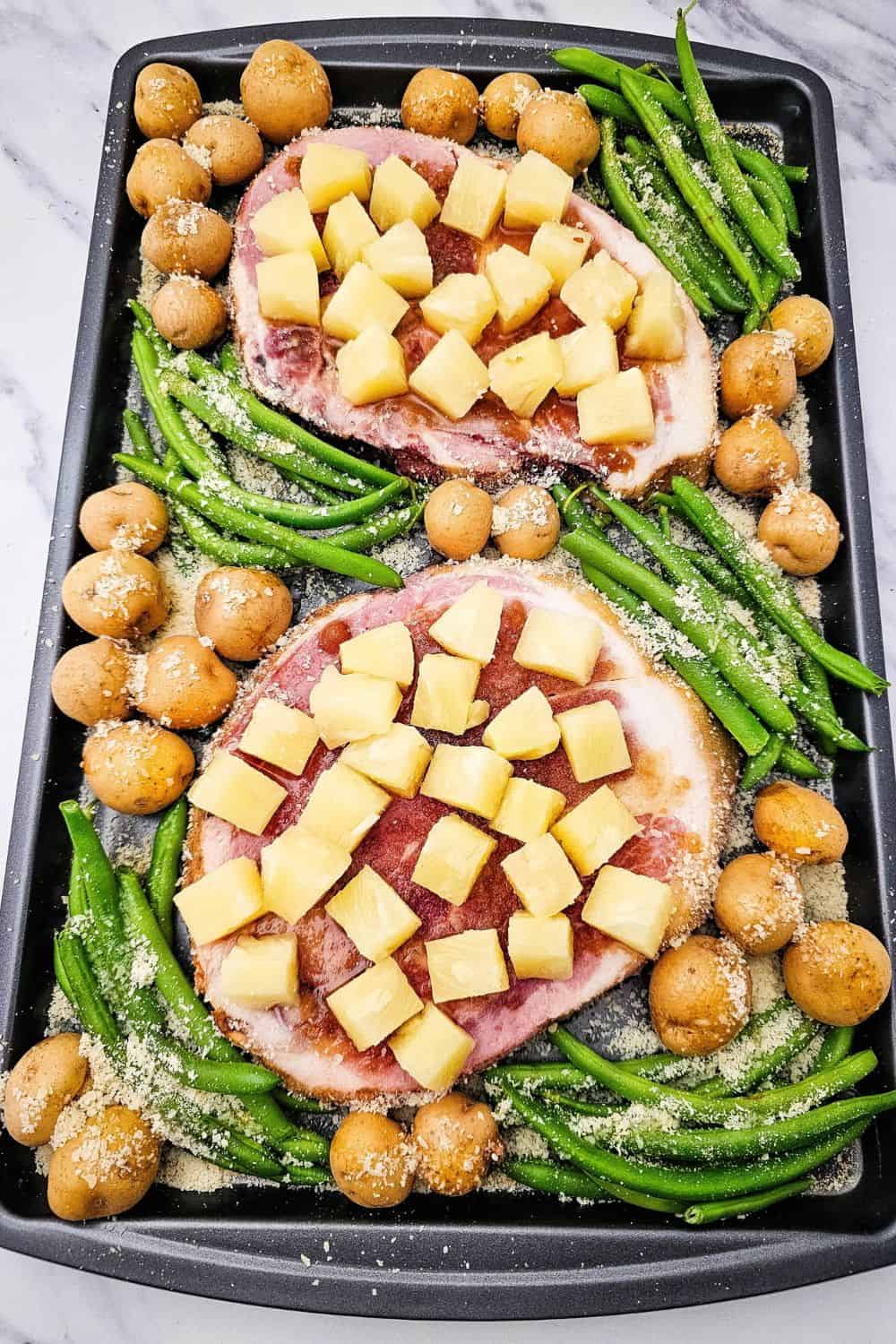 Looking for ham steak recipes baked in oven that actually taste like something? Press brown sugar into thick ham steaks, pile on pineapple chunks, and roast at 400 degrees with baby potatoes and green beans. The ham caramelizes, the potatoes get golden, and dinner is on the table in 35 minutes. An easy ham steak dinner, a one sheet pan meal, and a cozy family dinner idea all in one. Pin this to try this week!