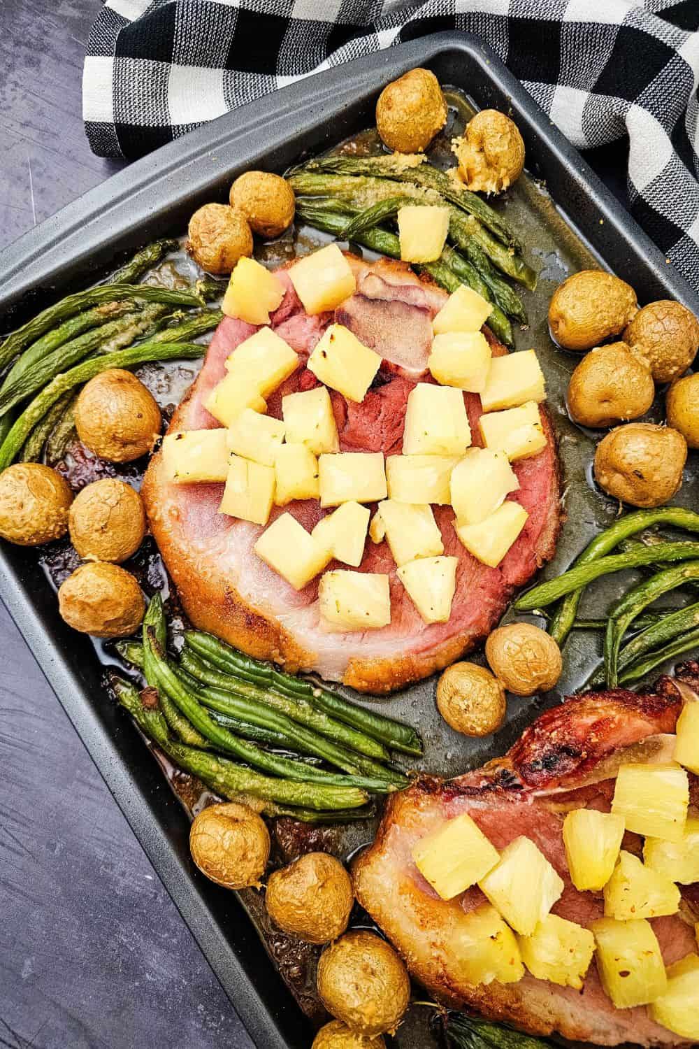 Looking for ham steak recipes baked in oven that actually taste like something? Press brown sugar into thick ham steaks, pile on pineapple chunks, and roast at 400 degrees with baby potatoes and green beans. The ham caramelizes, the potatoes get golden, and dinner is on the table in 35 minutes. An easy ham steak dinner, a one sheet pan meal, and a cozy family dinner idea all in one. Pin this to try this week!