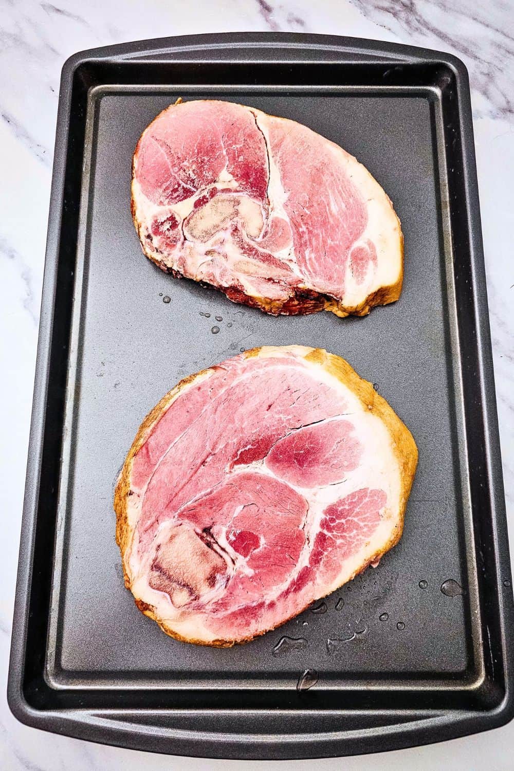 Looking for ham steak recipes baked in oven that actually taste like something? Press brown sugar into thick ham steaks, pile on pineapple chunks, and roast at 400 degrees with baby potatoes and green beans. The ham caramelizes, the potatoes get golden, and dinner is on the table in 35 minutes. An easy ham steak dinner, a one sheet pan meal, and a cozy family dinner idea all in one. Pin this to try this week!