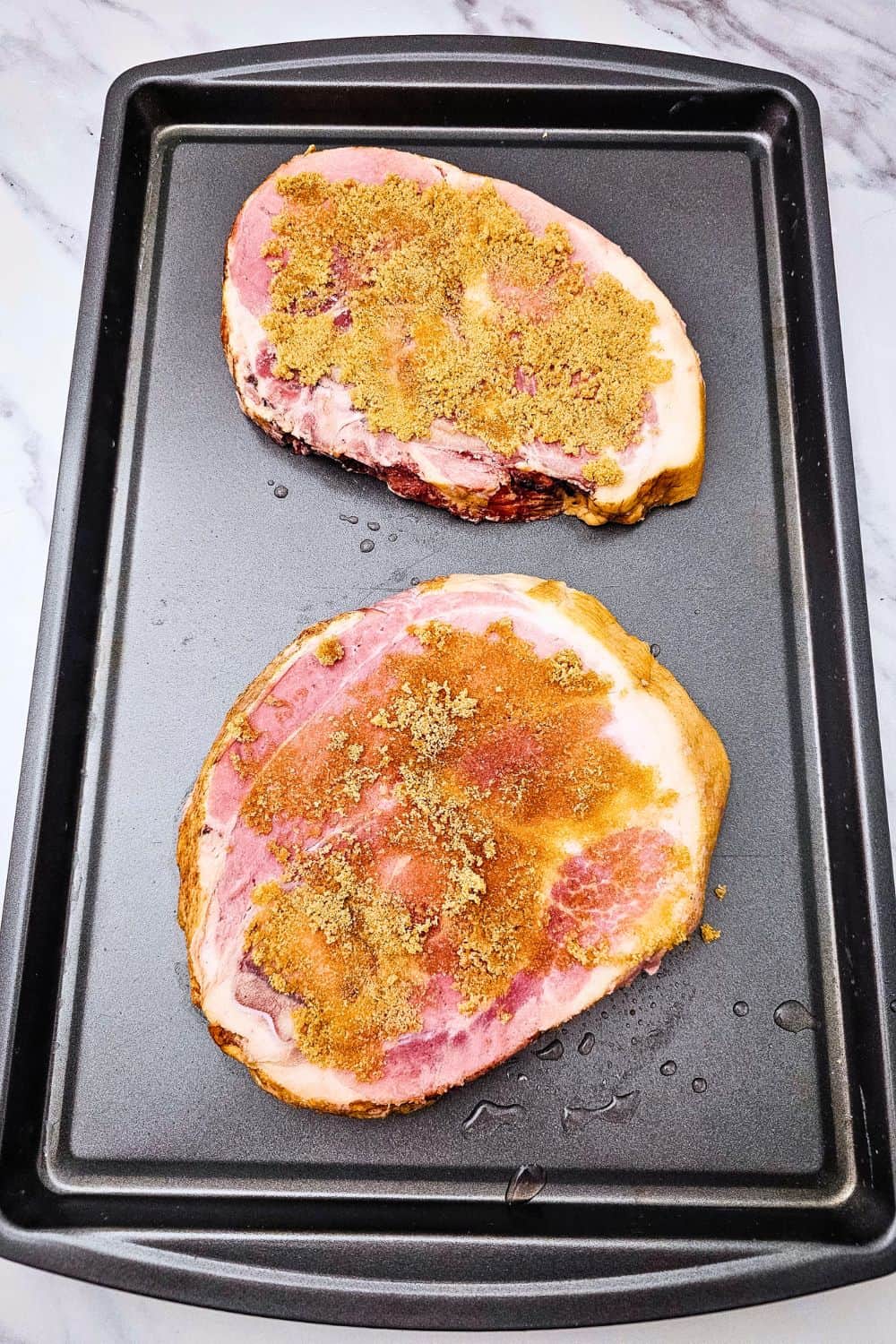 Looking for ham steak recipes baked in oven that actually taste like something? Press brown sugar into thick ham steaks, pile on pineapple chunks, and roast at 400 degrees with baby potatoes and green beans. The ham caramelizes, the potatoes get golden, and dinner is on the table in 35 minutes. An easy ham steak dinner, a one sheet pan meal, and a cozy family dinner idea all in one. Pin this to try this week!