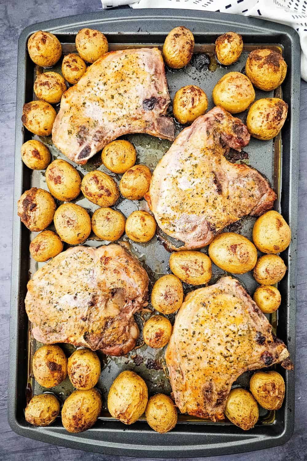 These sheet pan ranch pork chops and potatoes are the easy one pan dinner you need on a busy weeknight. Juicy pork chops and tender baby potatoes get tossed in ranch seasoning, paprika and oregano, then roasted together in the oven for a hearty, comforting meal with barely any cleanup. A simple pork chop sheet pan dinner that serves four. Save this easy pork chop recipe for your next family dinner!