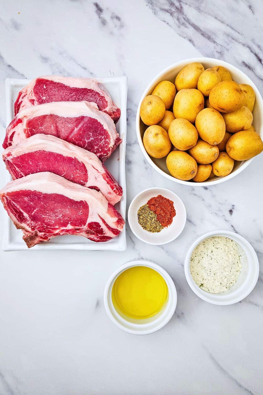 These sheet pan ranch pork chops and potatoes are the easy one pan dinner you need on a busy weeknight. Juicy pork chops and tender baby potatoes get tossed in ranch seasoning, paprika and oregano, then roasted together in the oven for a hearty, comforting meal with barely any cleanup. A simple pork chop sheet pan dinner that serves four. Save this easy pork chop recipe for your next family dinner!