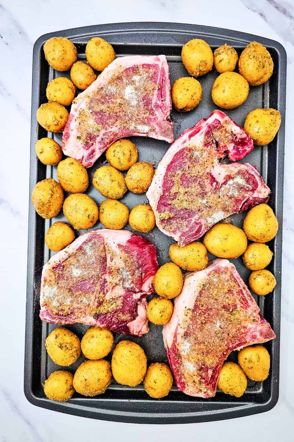 These sheet pan ranch pork chops and potatoes are the easy one pan dinner you need on a busy weeknight. Juicy pork chops and tender baby potatoes get tossed in ranch seasoning, paprika and oregano, then roasted together in the oven for a hearty, comforting meal with barely any cleanup. A simple pork chop sheet pan dinner that serves four. Save this easy pork chop recipe for your next family dinner!